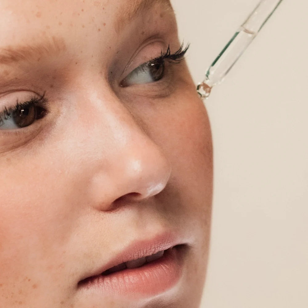Girl applying Salvarity face serum to skin