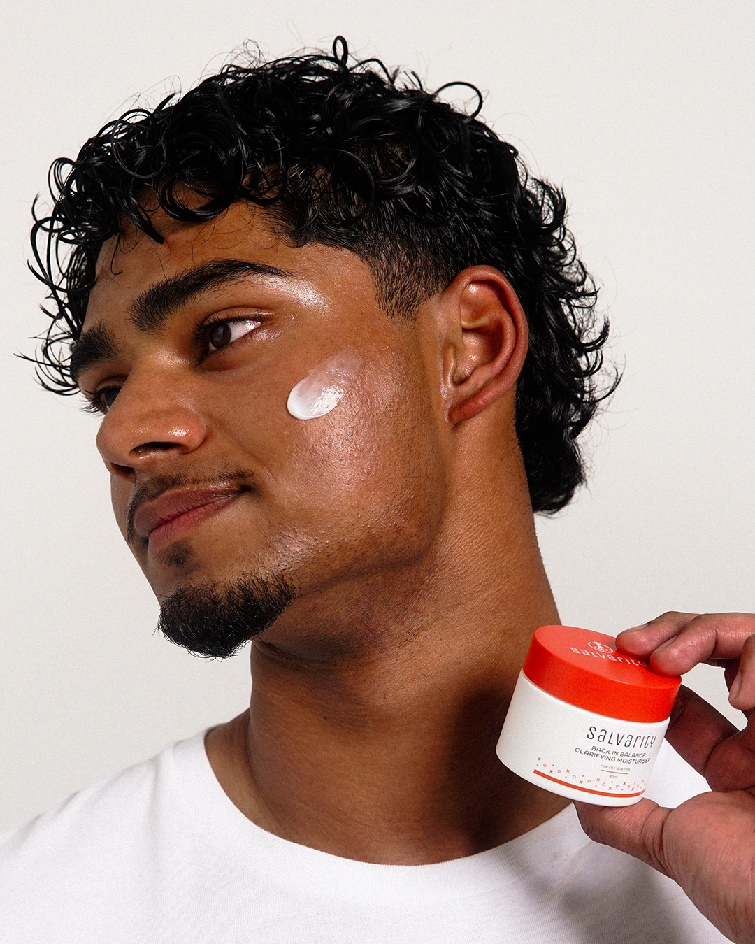 Man applying moisturiser to his face 