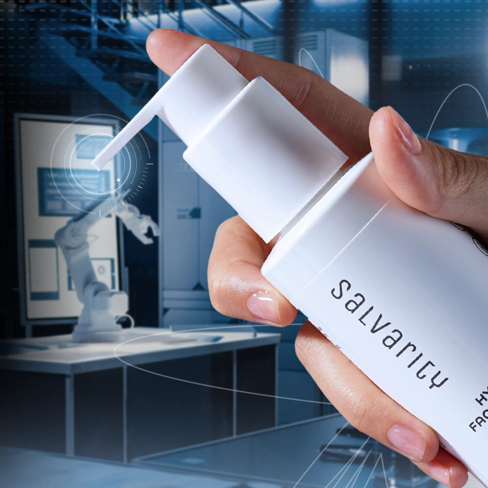 Hand holding Salvarly facial cleanser pump bottle in a futuristic lab setting with robotic arm in the background.