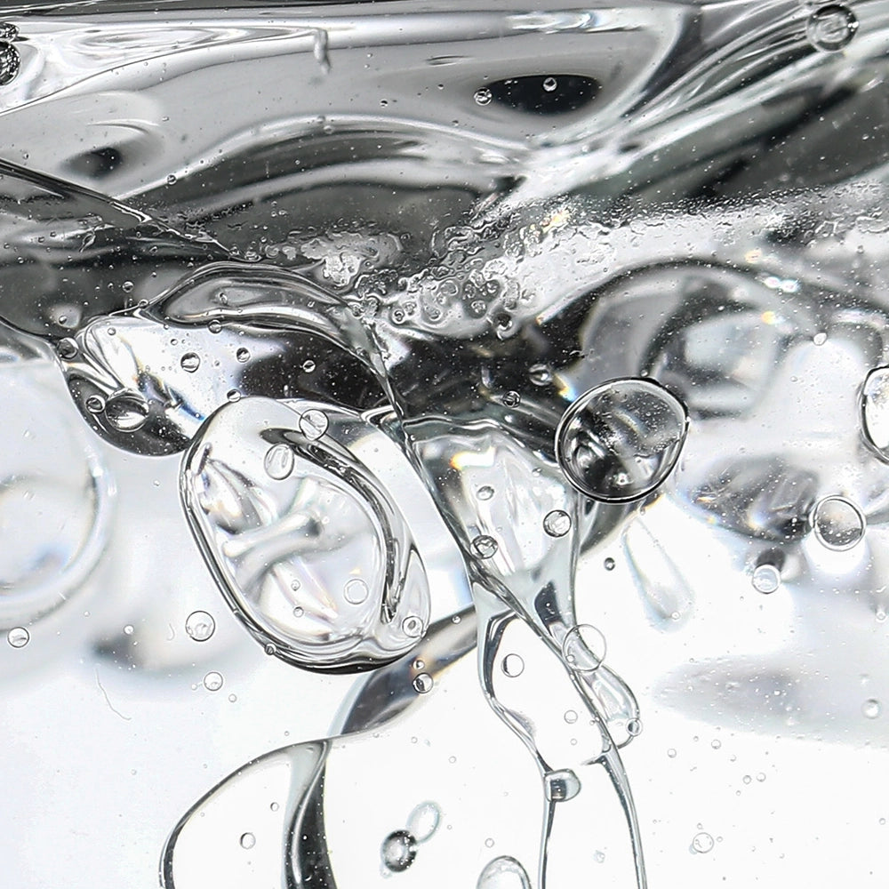Close-up of water droplets and bubbles on a reflective surface