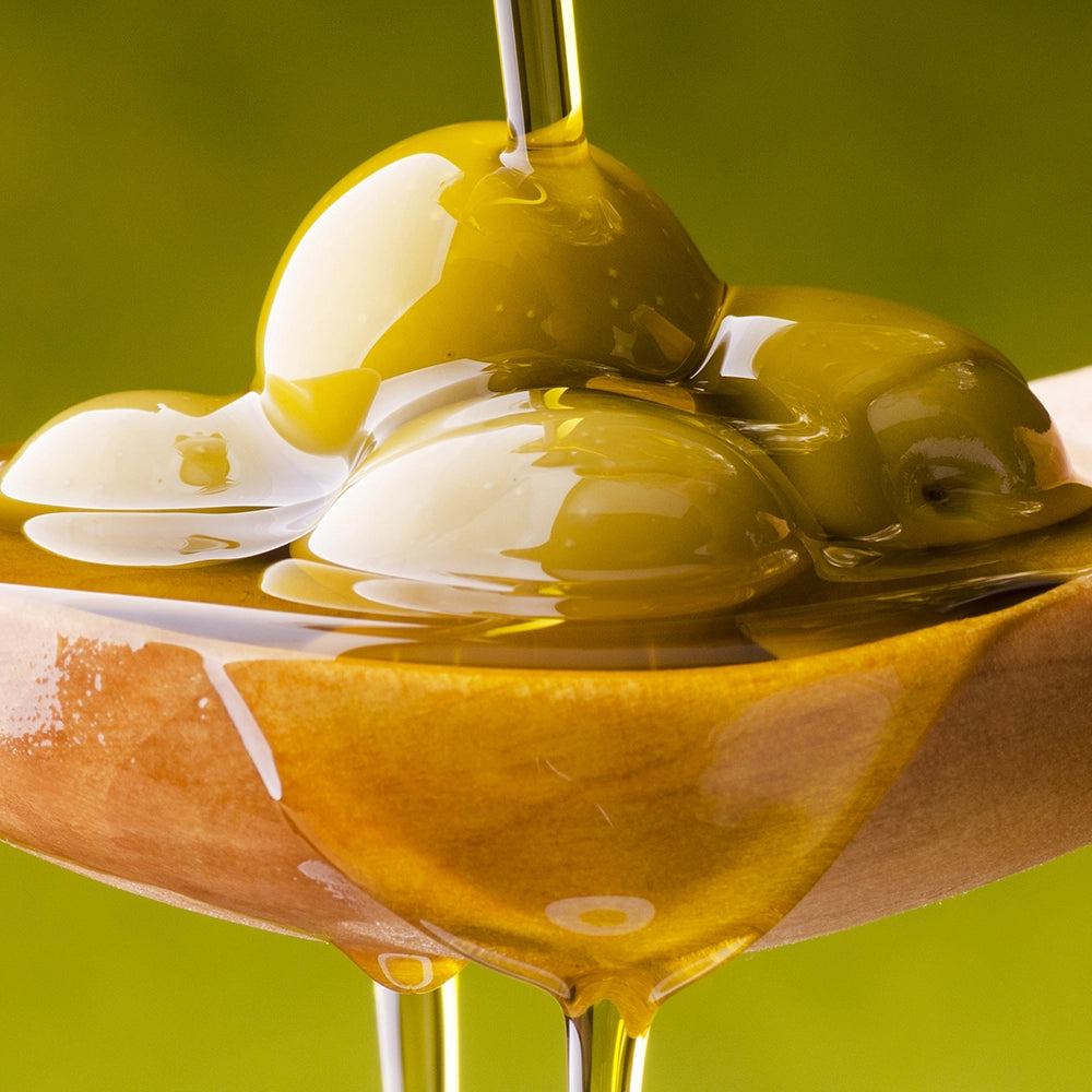 Squalane-rich olive oil on spoon illustrating skin barrier protection.